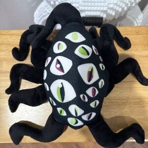 Black Plush Toy with Eye Pattern